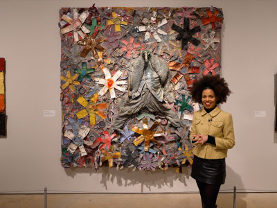 Emma Dabiri standing in front of ‘Stars of Everything’, 2004, by Thornton Dial, in ‘Souls Grown Deep like the Rivers: Black Artists from the American South’ at the Royal Academy of Arts, London, from 17 March - 18 June 2023