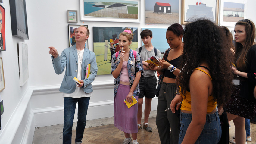 Gallerist Simon Oldfield leading a tour of the Summer Exhibition