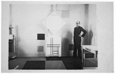 Mondrian in his Paris studio in 1933 with Lozenge Composition with Four Yellow Lines, 1933 and Composition with Double Lines and Yellow, 1933.