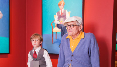 Rufus Hale and David Hockney photographed in front of Hockney's portrait of Rufus