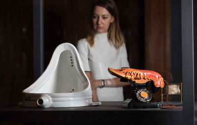 Installation view of the Dalí / Duchamp Exhibition at the Royal Academy of Arts, London, showing 'Fountain' by Marcel Duchamp and 'Lobster Telephone' by Salvador Dalí