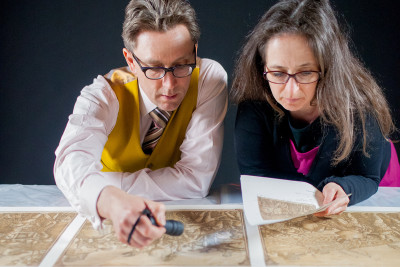 Conservators Graeme Gardiner and Karine Bovagnet check 'The Triumph of Julias Caesar: Musicians and Standard Bearers' ('The Musicians'), 1599, by Andrea Andreani, after Mantegna, now on display in the RA's 'Renaissance Impressions'