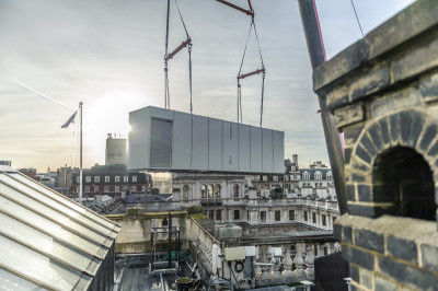 The new air conditioning plant is lifted towards its new home in the Main Galleries