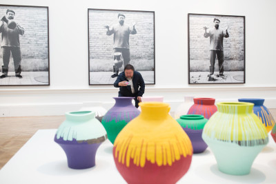 Ai Weiwei taking a photograph of his installation Coloured Vases
