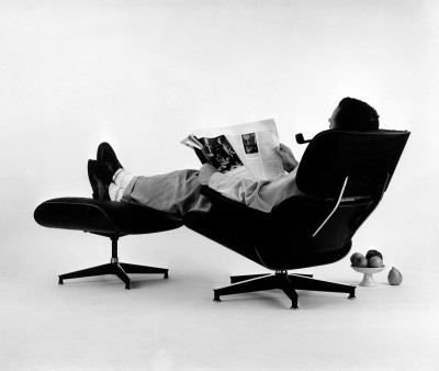Charles Eames in the plywood Lounge and Ottoman. Photograph for an advertisement,1956: The World of Charles and Ray Eames