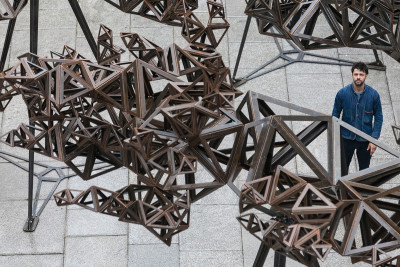 Royal Academician Conrad Shawcross stands in front of 'The Dappled Light of the Sun', 2015