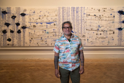 John Pule, in front of 'Kehe tau hauaga foou - To All New Arrivals', 2007, in the Memory and Commemoration room in the Oceania exhibition at the Royal Academy of Arts, London, 29 September – 10 December 2018