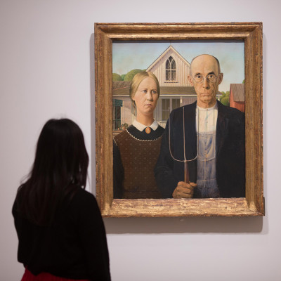 Installation view of ‘America after the Fall: Painting in the 1930s’ at the Royal Academy of Arts, London, showing 'American Gothic' by Grant Wood