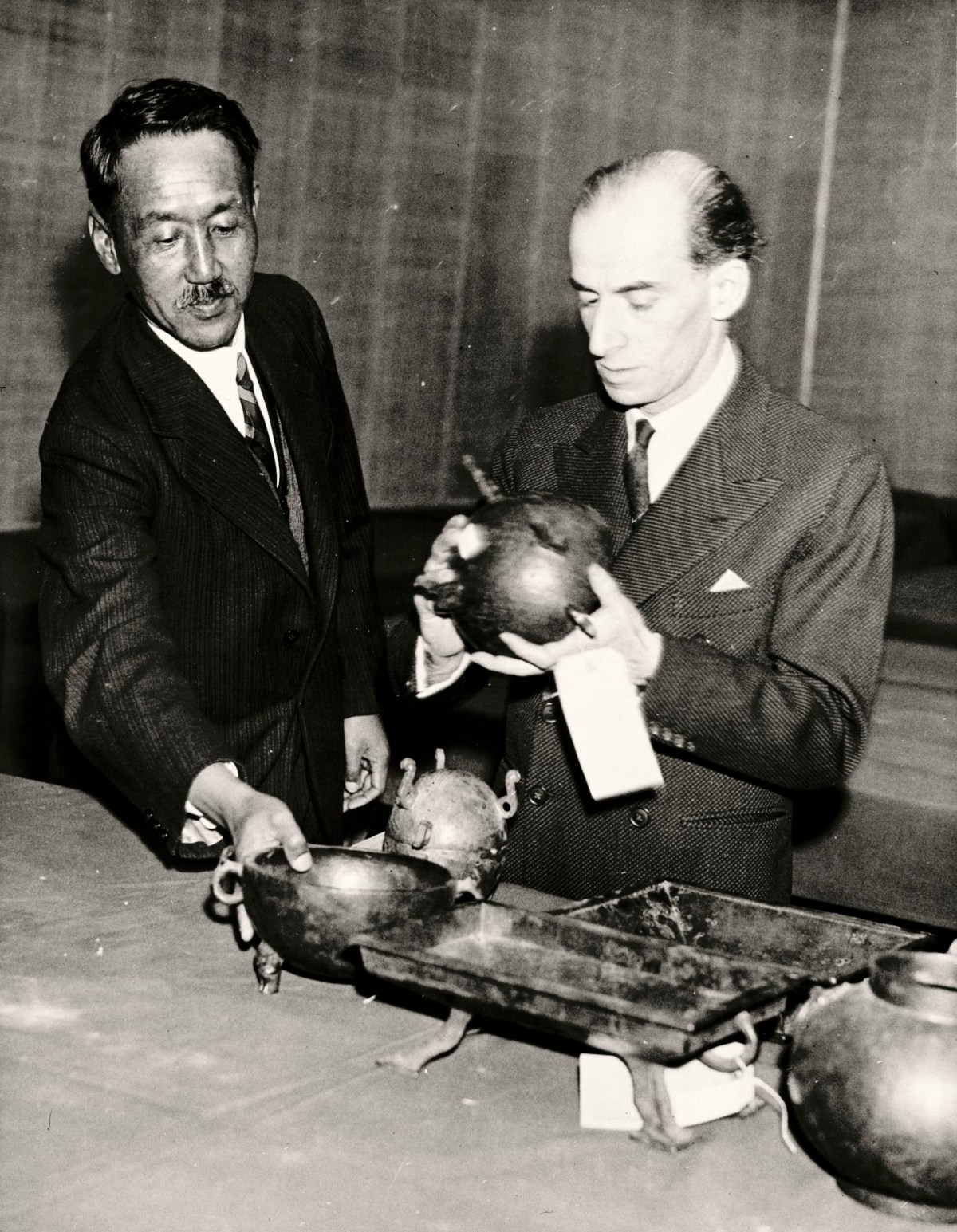 Unidentified photographer, The International Exhibition of Chinese Art at the Royal Academy 1935-6: Sir Percival David, Exhibition Committee Director and Tang Xifen (Tang Hsi Fen) Exhibition Secretary, examining exhibits