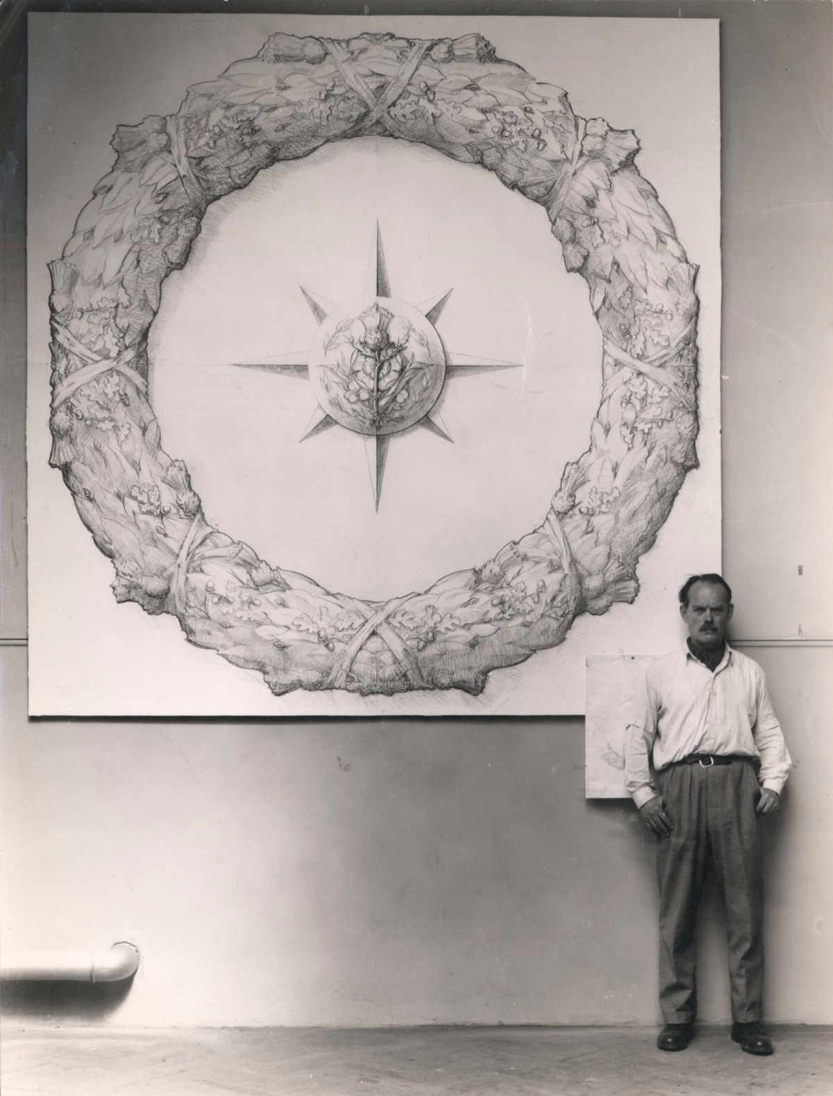 Unidentified photographer, Maurice Lambert with the design for the 'Star of India' memorial wreath for merchant seamen