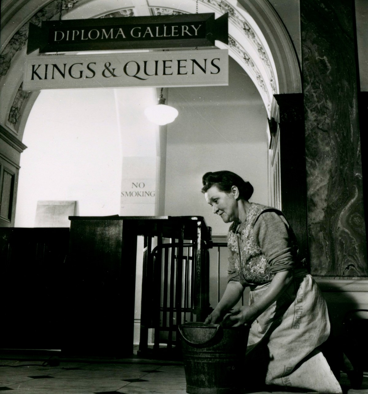 Russell Westwood, A member of the cleaning staff at work in the entrance hall of Burlington House, 1953.