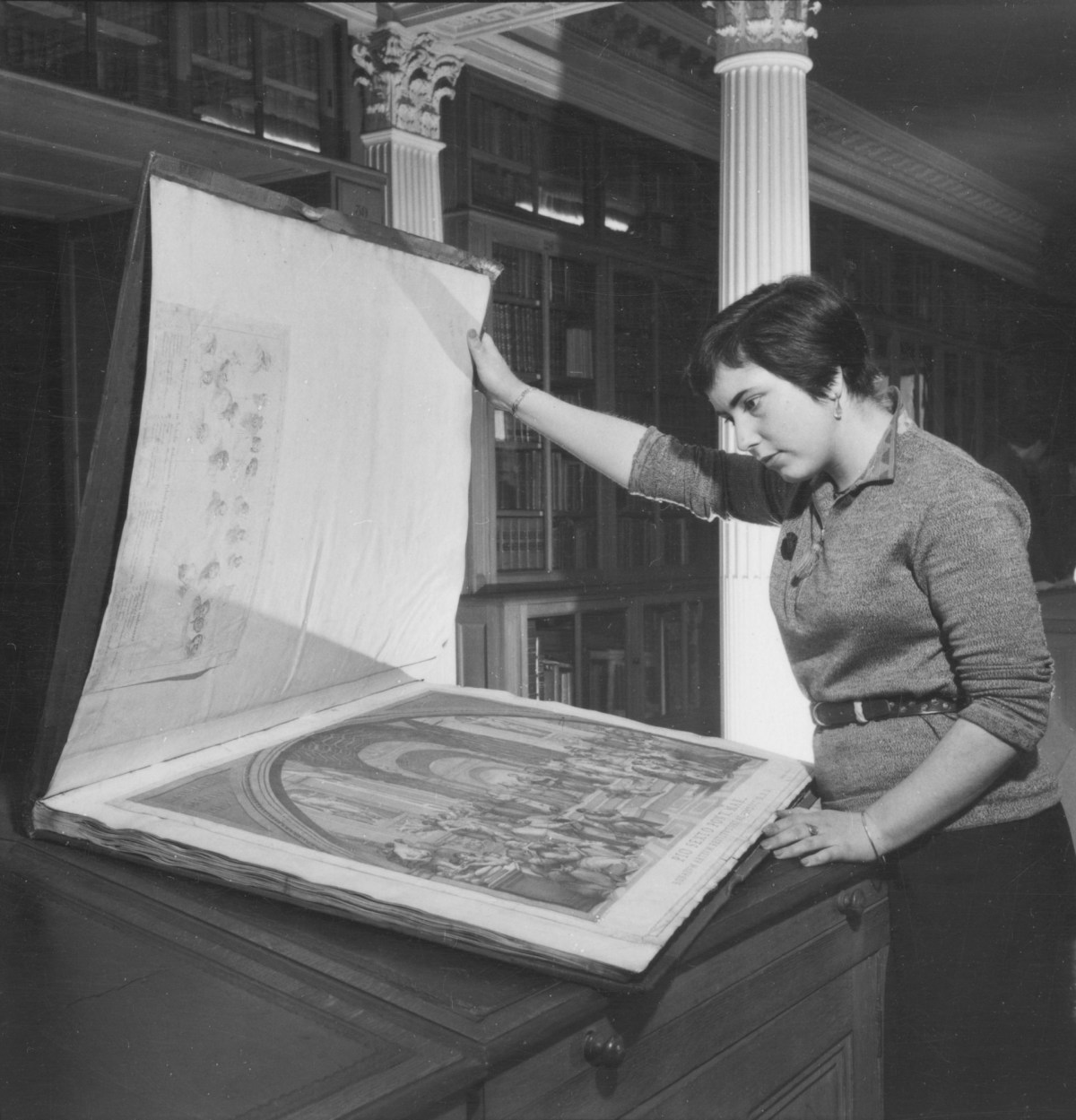 Russell Westwood, Ingrid Unger, a painting student examines an album of prints in the Royal Academy Library 1953.