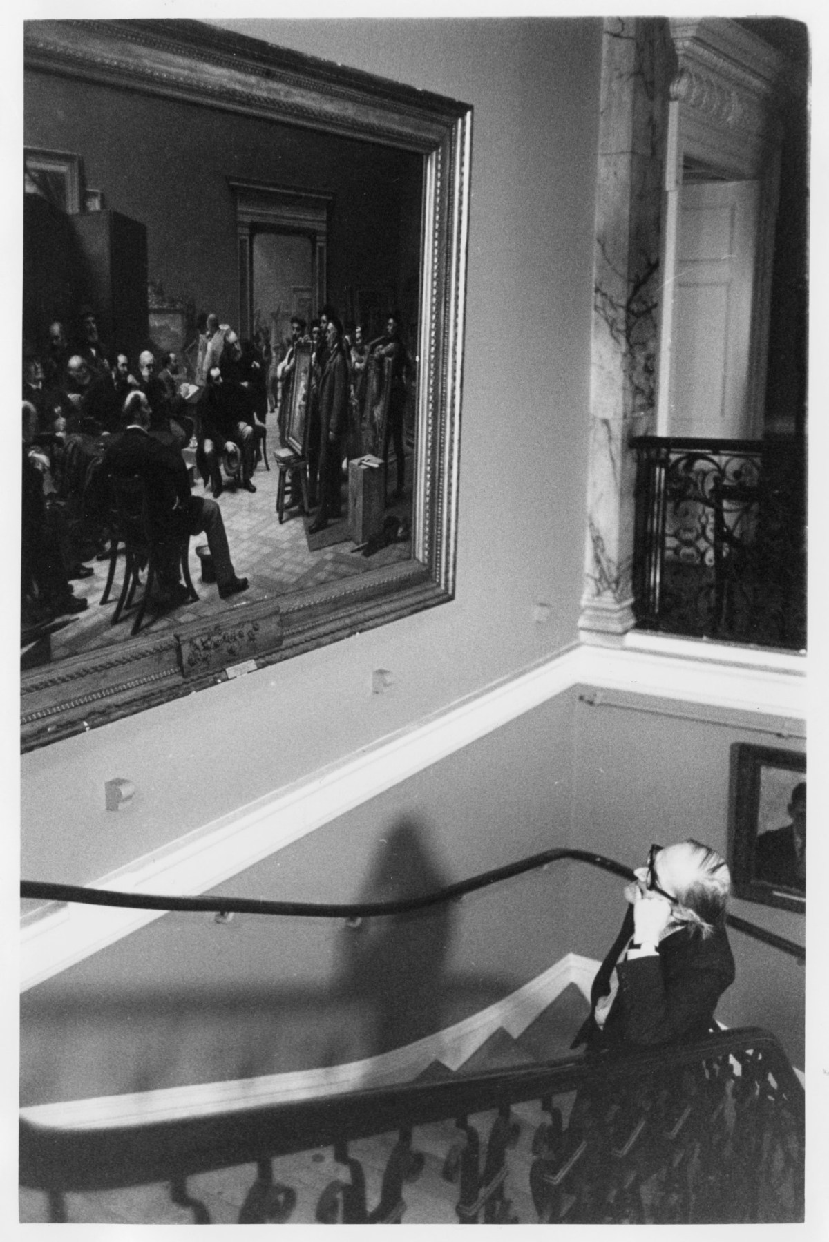 Anne James, Sir Hugh Casson P.R.A. standing on the Norman Shaw staircase, Burlington House.
