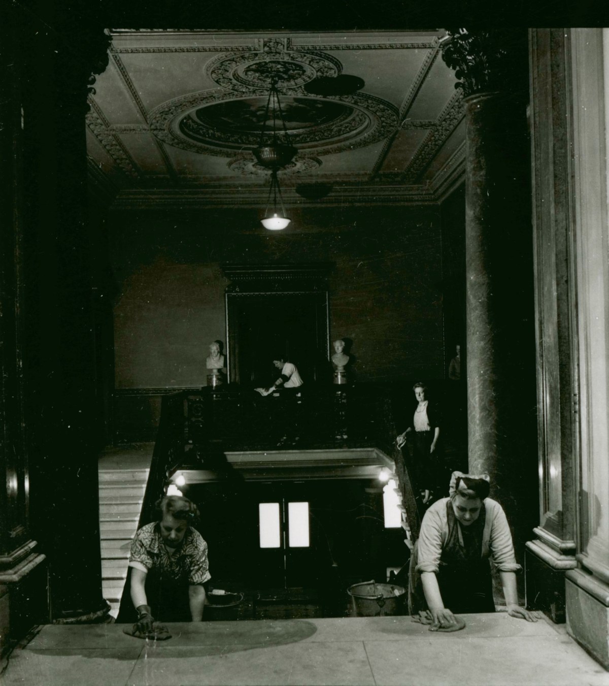 Russell Westwood, Cleaning staff at work on the main staircase, Royal Academy of Arts, Burlington House, 1953.