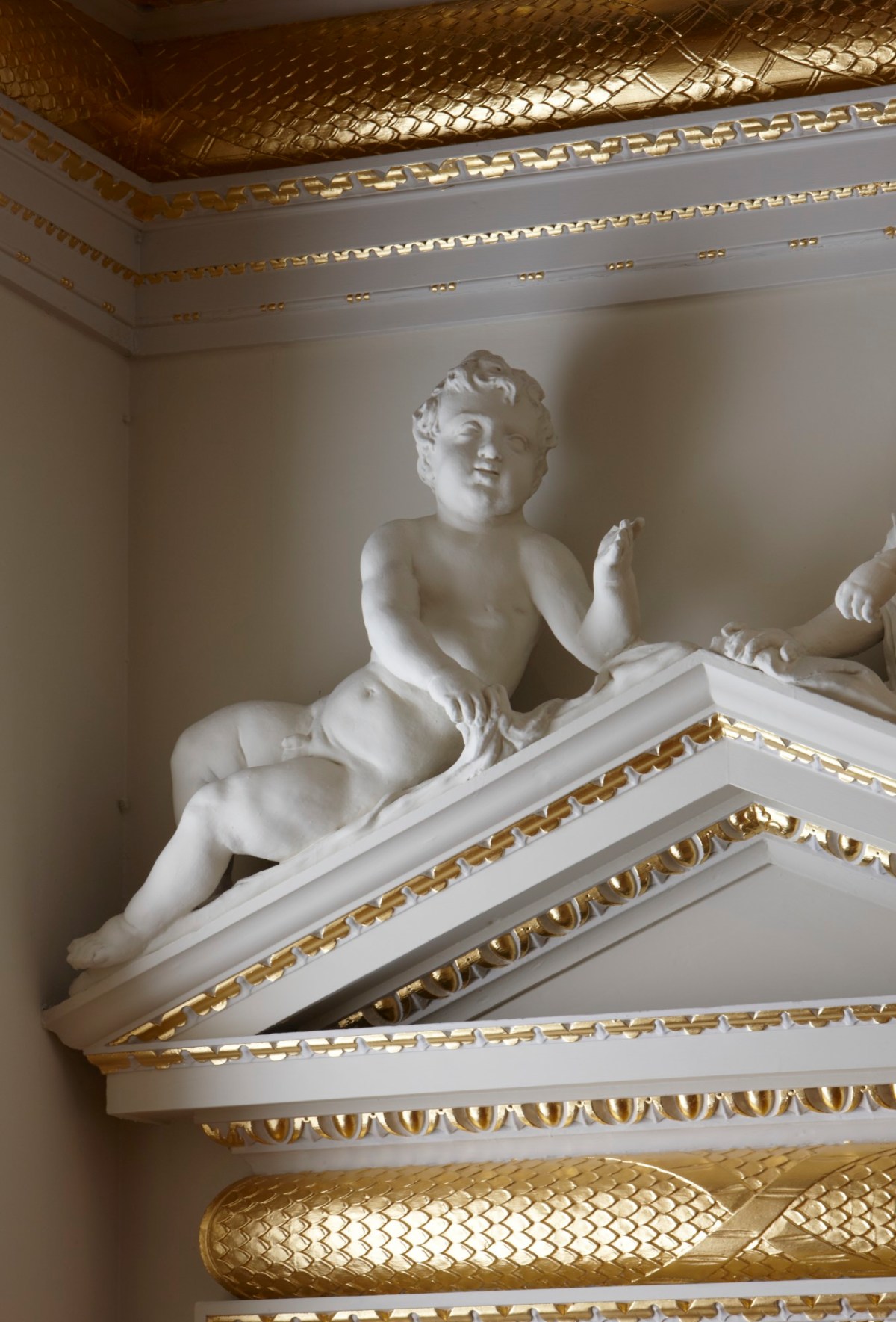 Paul Highnam, Cherub above the pediment of the doorcase leading from the Saloon to the Slaughter Room.