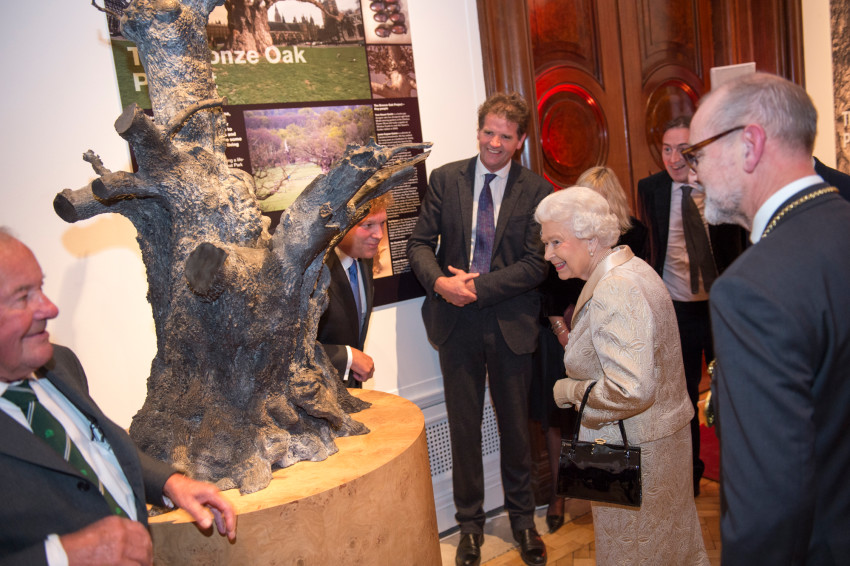 The Queen is presented with a bronze replica of a 900-year-old tree in Windsor Great Park