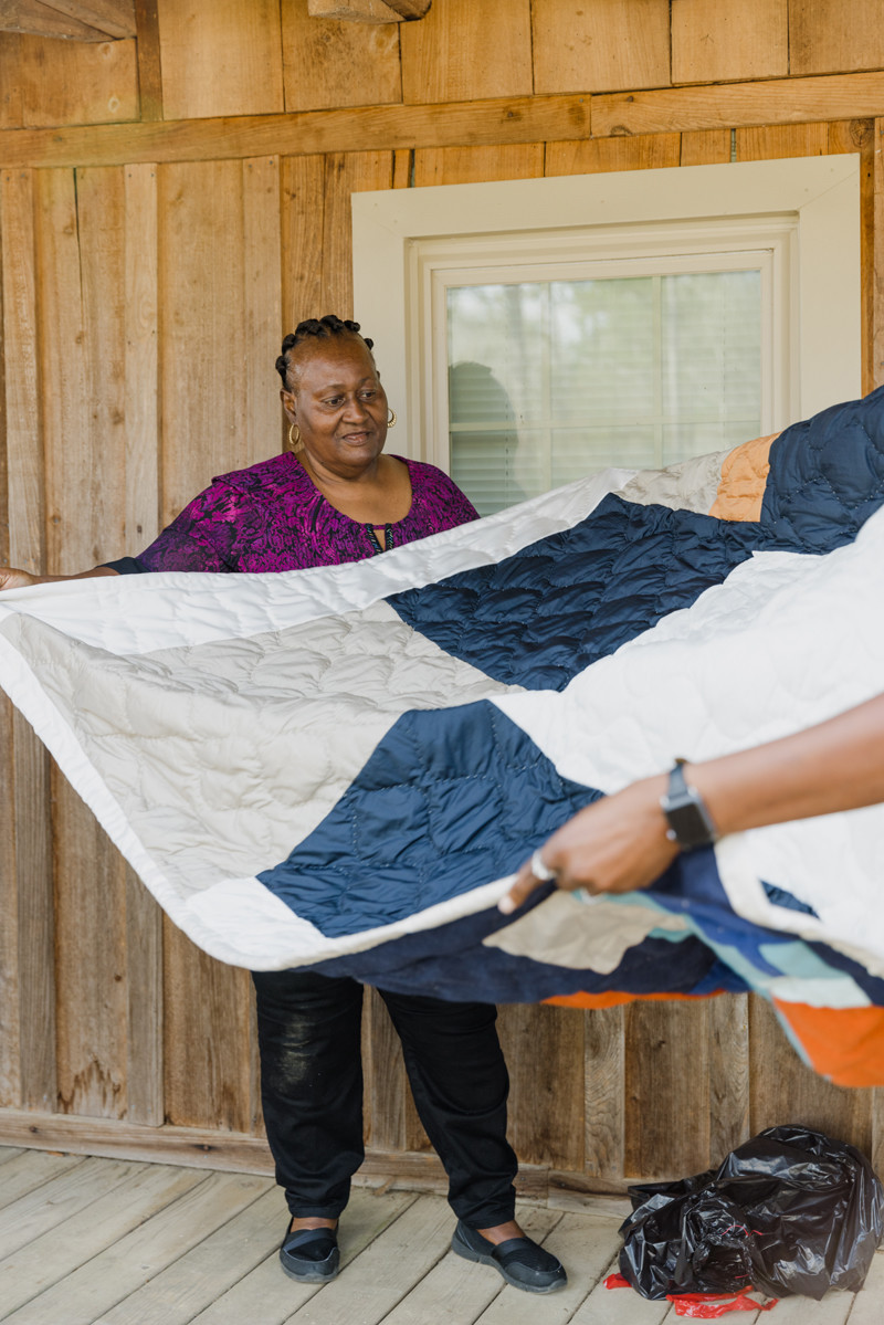 Sharon Williams with a quilt made by her and Cassandra Pettway