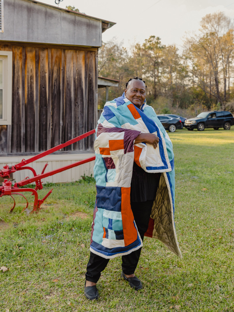 Sharon Williams wrapped in the quilt made by her and Cassandra Pettway