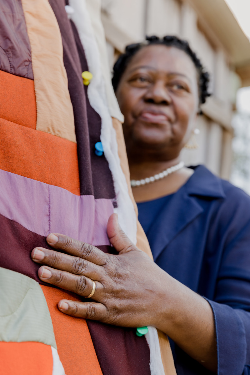 Doris Pettway-Mosely with the quilt made by her and Monica Waller