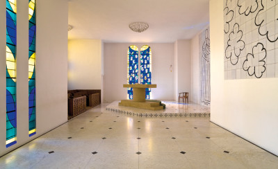 The interior of the chapel with the altar and the Tree of Life stained-glass window