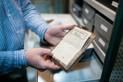 Archivist Mark Pomeroy displays an item from the archive