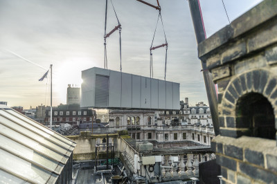 The new air conditioning plant is lifted towards its new home in the Main Galleries