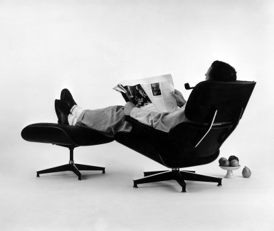 Charles Eames in the plywood Lounge and Ottoman. Photograph for an advertisement,1956: The World of Charles and Ray Eames